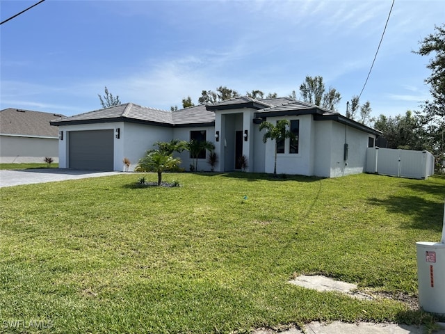 view of front of home featuring a garage and a front lawn