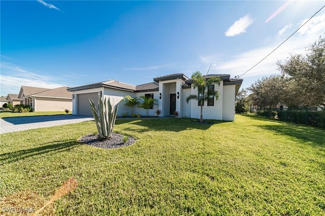 view of front of property with a garage and a front yard