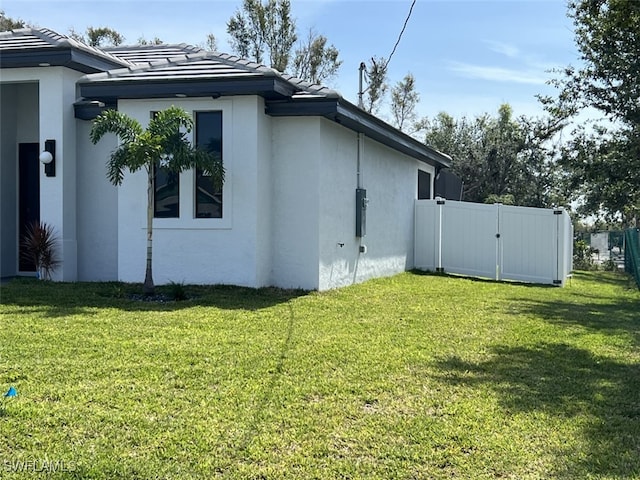 view of side of property with a lawn