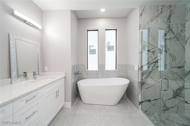 bathroom featuring vanity and shower with separate bathtub