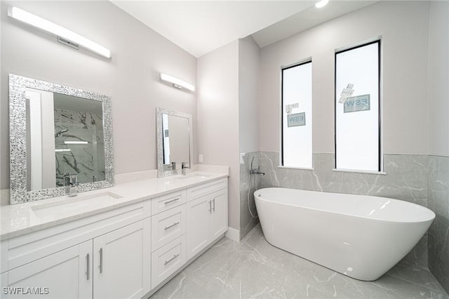 bathroom featuring vanity and separate shower and tub