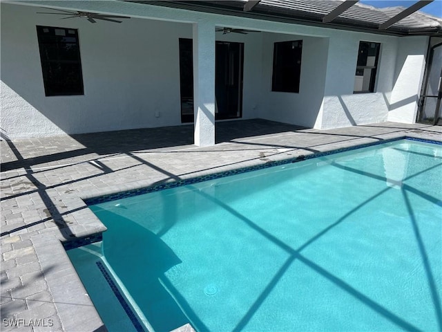 view of pool featuring ceiling fan, a lanai, and a patio