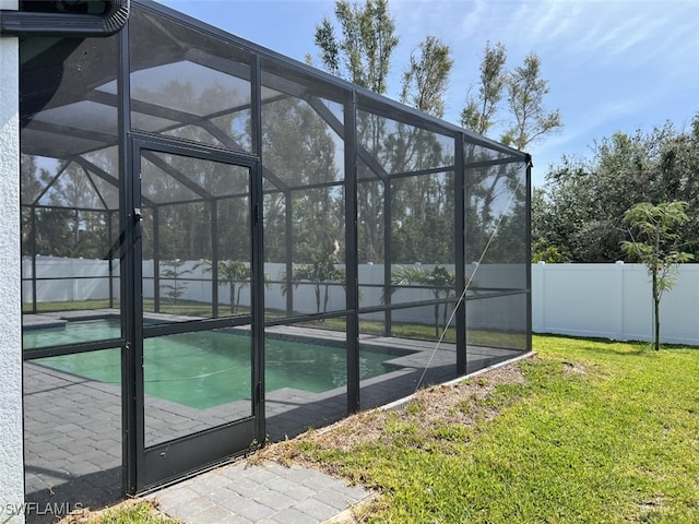 exterior space with a fenced in pool and a lawn