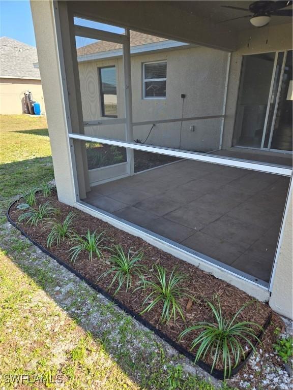 exterior space featuring ceiling fan