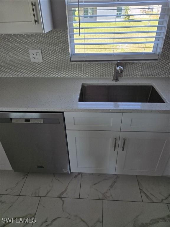 kitchen with sink, white cabinetry, dishwasher, and tasteful backsplash