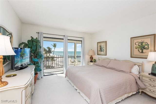 bedroom with light colored carpet and access to exterior