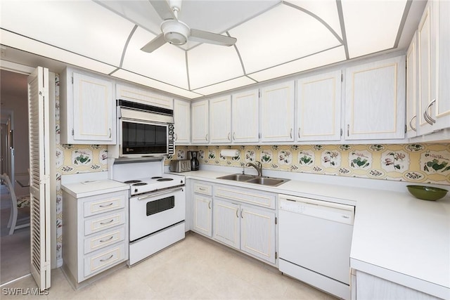 kitchen with ceiling fan, sink, white appliances, and white cabinets