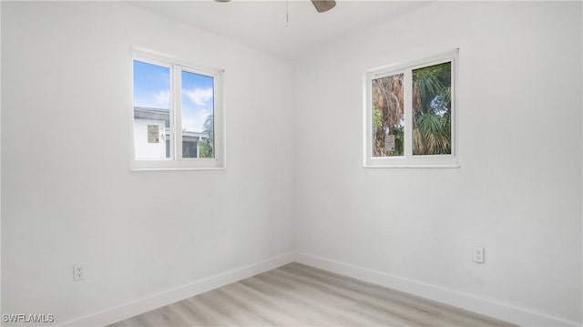 empty room with ceiling fan and light wood-type flooring