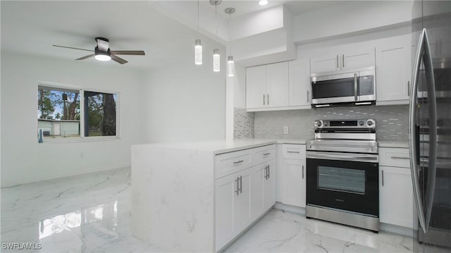 kitchen with kitchen peninsula, stainless steel appliances, decorative backsplash, and white cabinetry