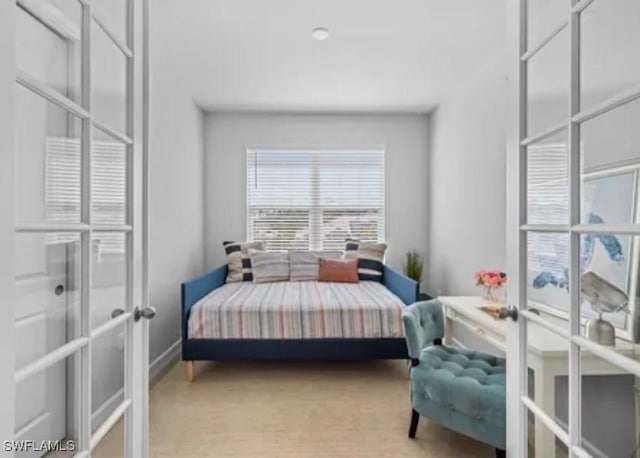 carpeted bedroom featuring french doors