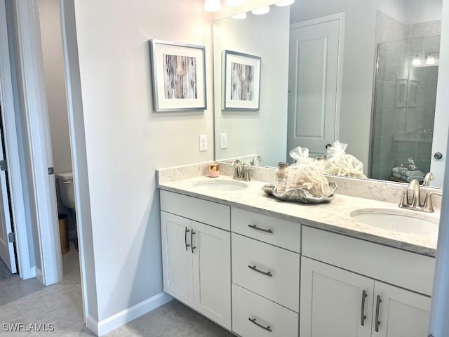 bathroom with a tile shower, toilet, vanity, and tile patterned flooring