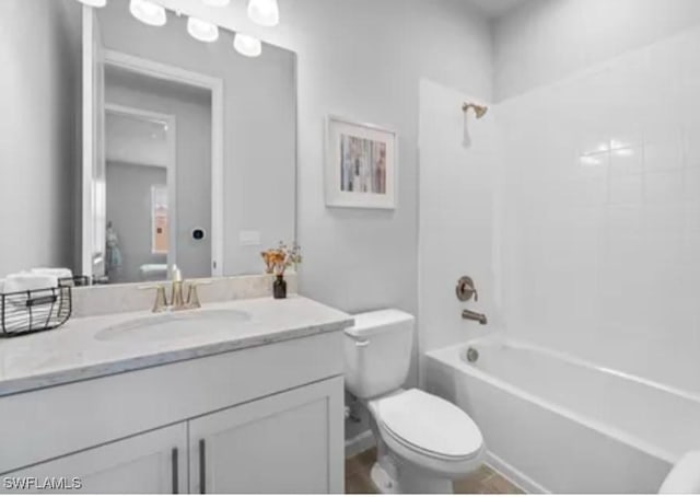 full bathroom featuring toilet, vanity, and  shower combination