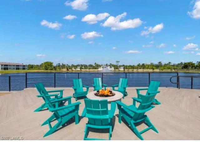 view of patio / terrace featuring an outdoor fire pit and a water view