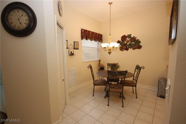 tiled dining space with an inviting chandelier