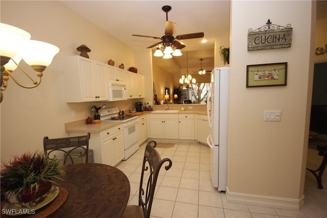 kitchen with sink, white cabinets, light tile patterned floors, kitchen peninsula, and white appliances