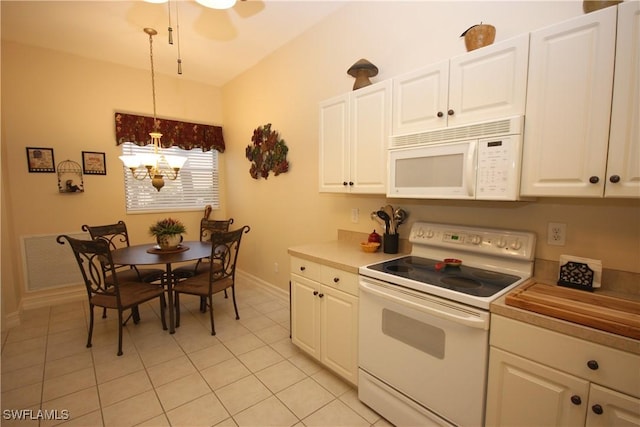 kitchen with light tile patterned flooring, ceiling fan with notable chandelier, pendant lighting, white cabinets, and white appliances