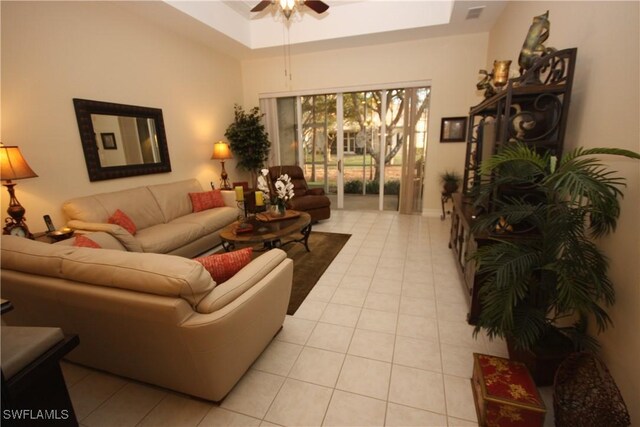 tiled living room with ceiling fan