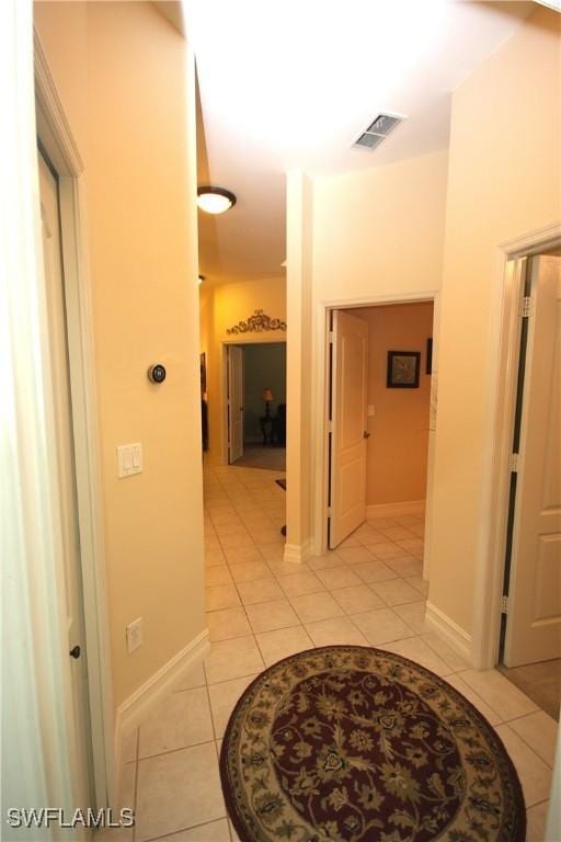 hall featuring light tile patterned floors