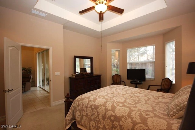 carpeted bedroom featuring a tray ceiling