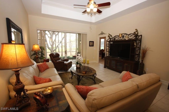 tiled living room featuring a tray ceiling and ceiling fan