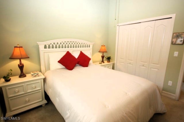 bedroom featuring dark colored carpet and a closet