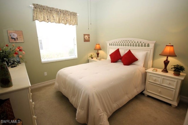 bedroom featuring light carpet