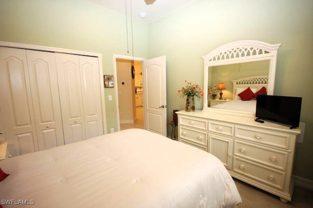 bedroom with vaulted ceiling and a closet