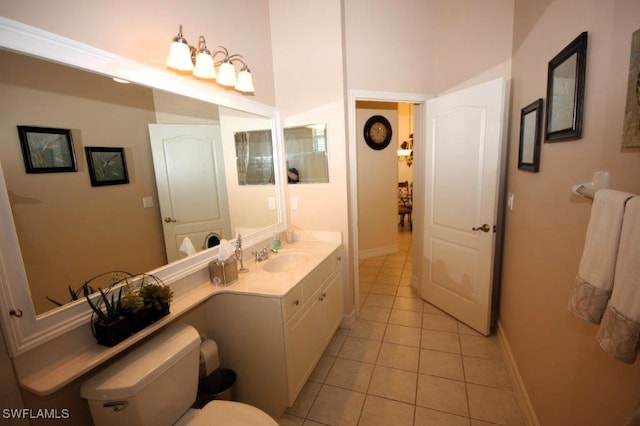 bathroom featuring vanity, tile patterned floors, and toilet