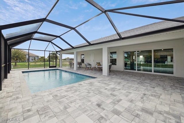 view of swimming pool featuring a lanai and a patio