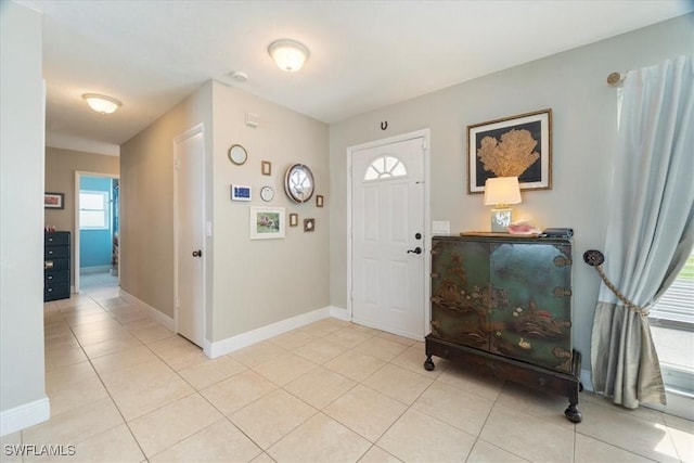 foyer entrance featuring light tile patterned flooring