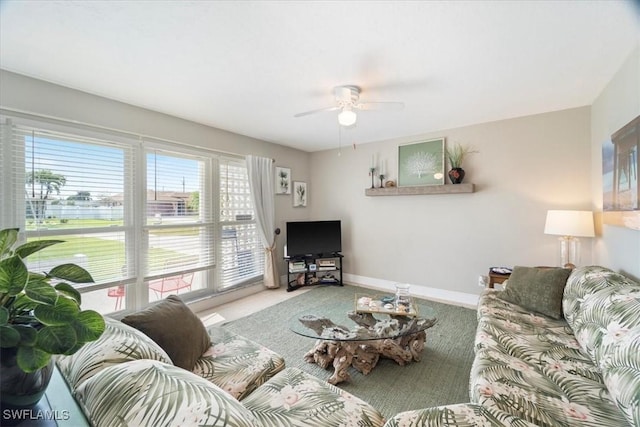 living room with ceiling fan and carpet flooring