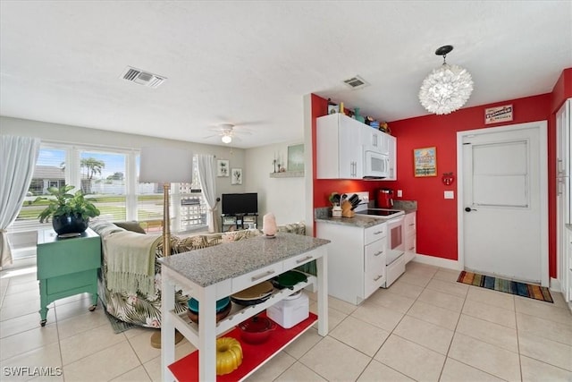 kitchen with ceiling fan with notable chandelier, white appliances, decorative light fixtures, white cabinetry, and light tile patterned flooring