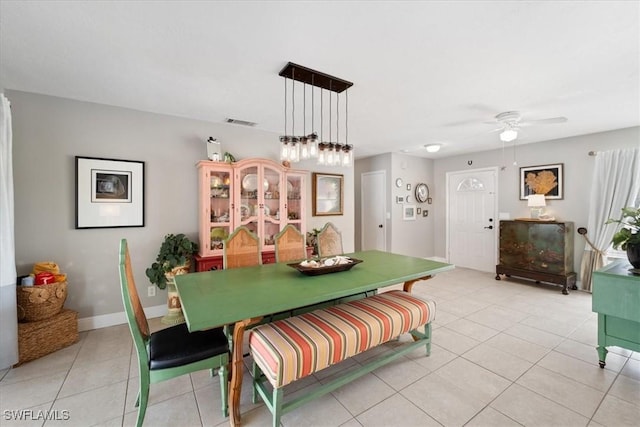 dining space with ceiling fan and light tile patterned flooring