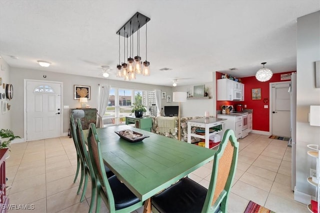 dining space featuring ceiling fan and light tile patterned flooring