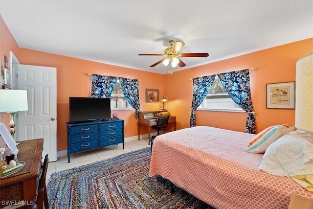 tiled bedroom featuring ceiling fan