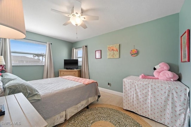 bedroom with ceiling fan and light tile patterned flooring