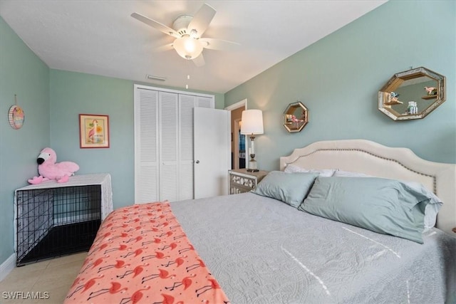 tiled bedroom with a closet and ceiling fan