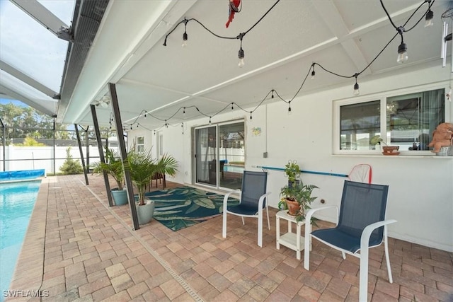 view of patio / terrace with a fenced in pool and glass enclosure