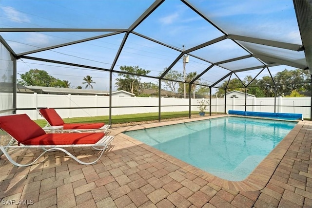 view of swimming pool featuring a lanai and a patio area