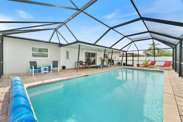 view of swimming pool featuring a patio area and a lanai