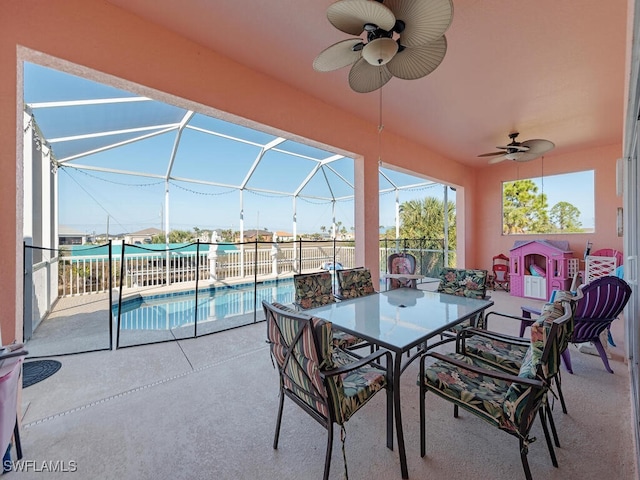 view of patio / terrace with ceiling fan, a fenced in pool, and glass enclosure