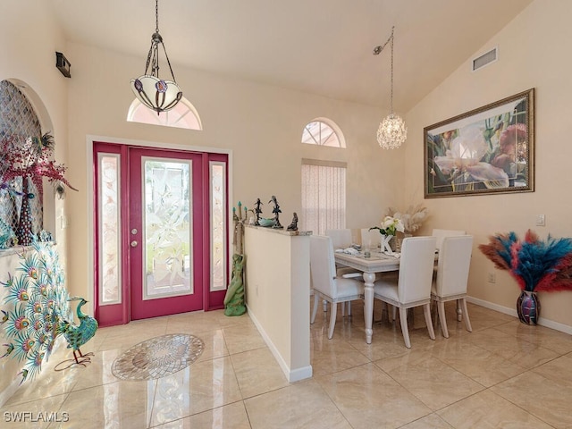 foyer entrance with high vaulted ceiling and a chandelier