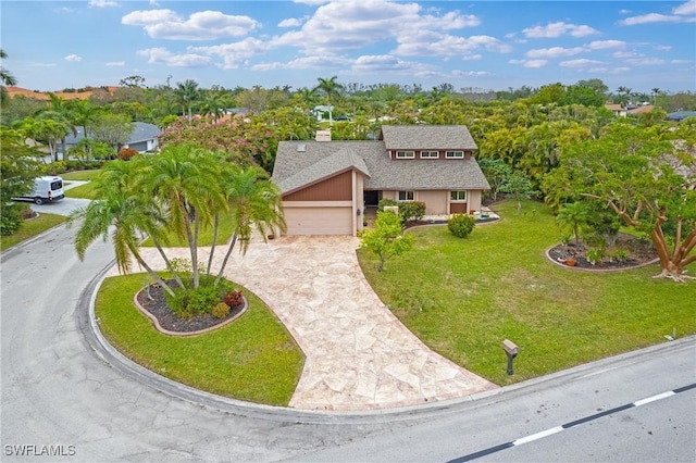 view of front of home featuring a garage and a front lawn