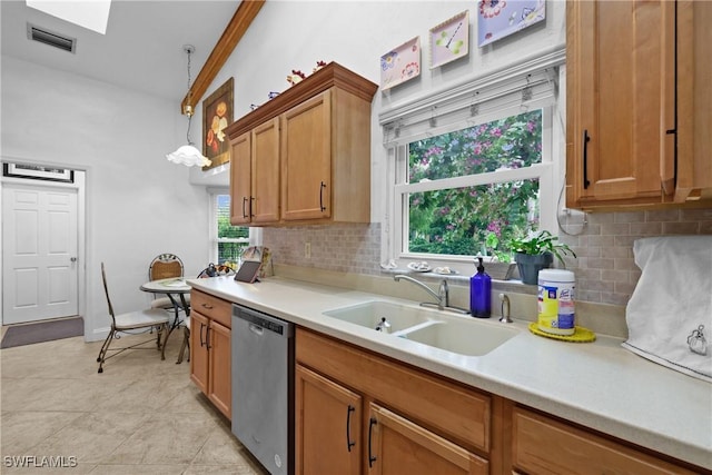 kitchen with sink, pendant lighting, dishwasher, and tasteful backsplash