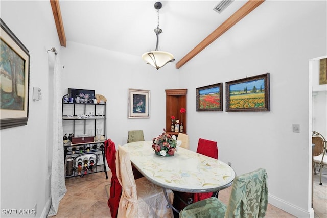 dining area with lofted ceiling with beams