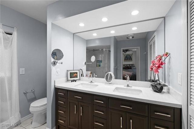 bathroom featuring toilet, vanity, and tile patterned flooring