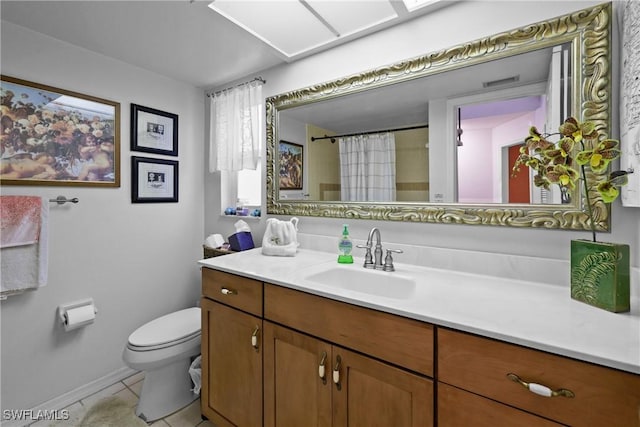 bathroom with vanity, toilet, and tile patterned floors