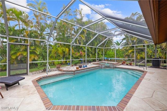 view of pool with an in ground hot tub, a patio, and a lanai