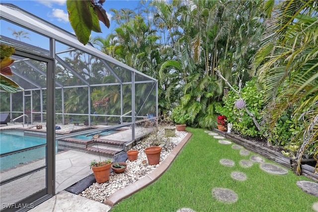 view of yard featuring a patio and a lanai