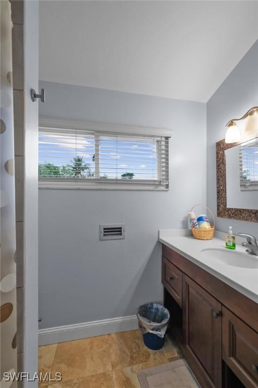 bathroom with tile patterned floors and vanity